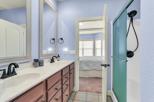 full bath with tile patterned flooring, a stall shower, and a sink