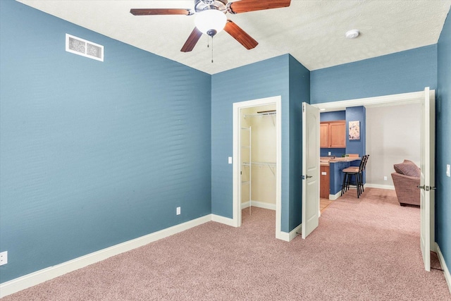 bedroom featuring visible vents, light carpet, baseboards, and ceiling fan