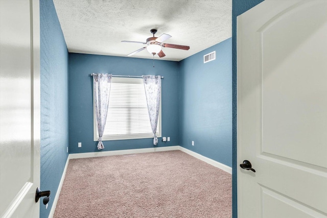 empty room with visible vents, ceiling fan, baseboards, and carpet floors