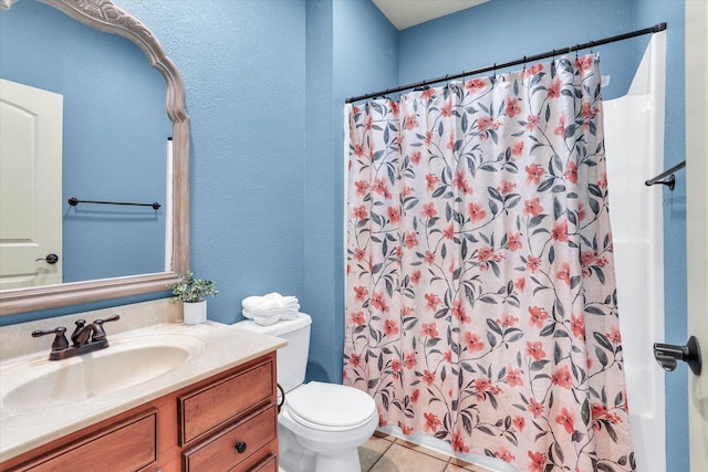 bathroom with tile patterned flooring, toilet, vanity, and a shower with curtain