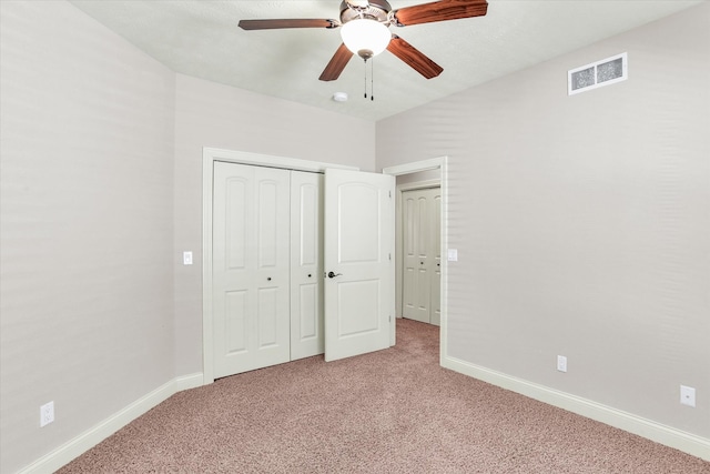 unfurnished bedroom featuring light colored carpet, visible vents, and baseboards