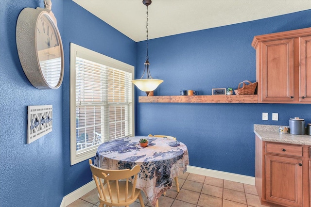 dining room with light tile patterned flooring and baseboards