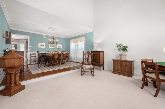 dining space with visible vents, light carpet, an inviting chandelier, and crown molding