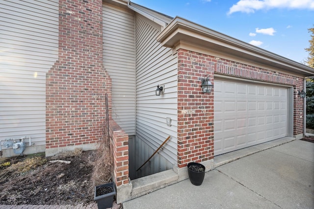 view of property exterior with a garage, brick siding, and concrete driveway