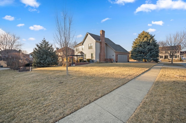 view of side of home featuring a lawn, a chimney, and a garage