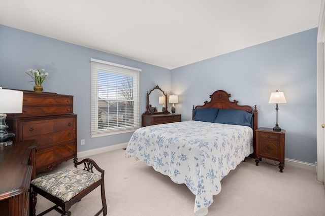 bedroom with baseboards and light carpet