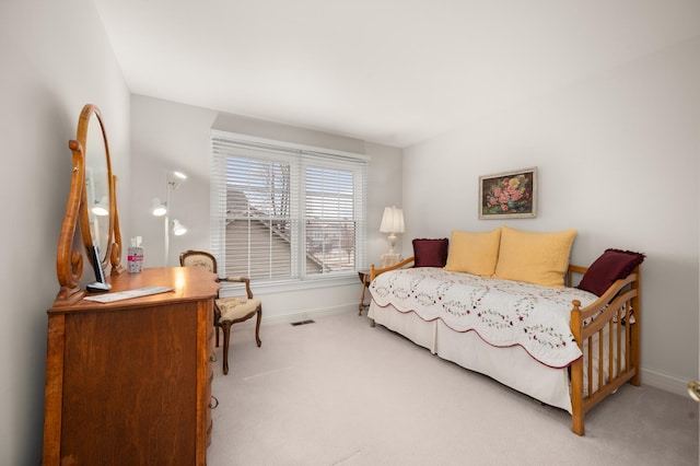 bedroom with visible vents, baseboards, and carpet