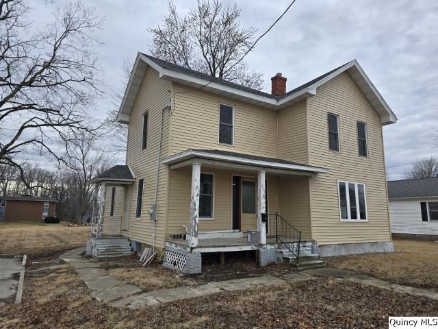 view of front of home featuring a chimney