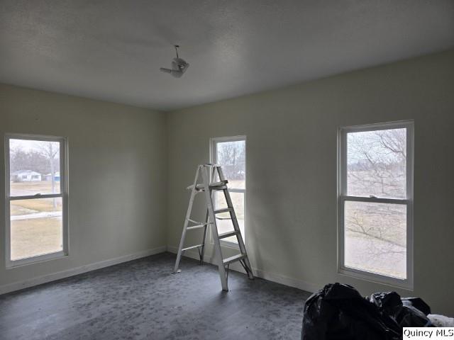 spare room featuring baseboards