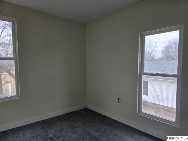 unfurnished room featuring baseboards