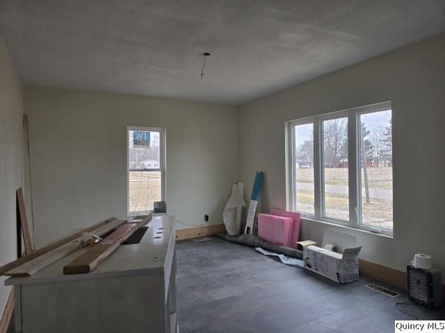 interior space featuring baseboards and wood finished floors