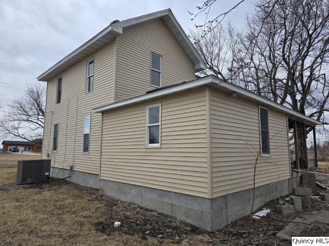 view of side of property with cooling unit