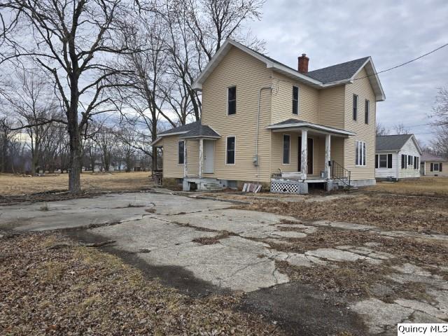 view of side of property with a chimney