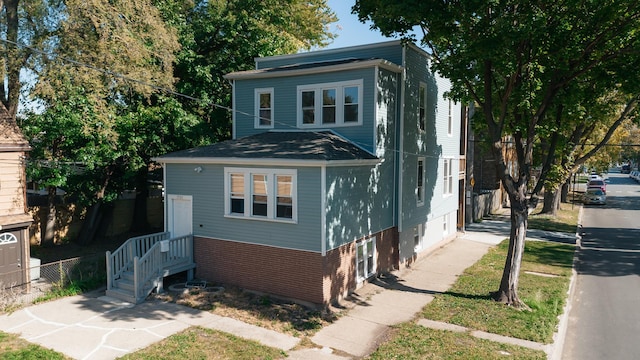 view of front of house with brick siding and fence