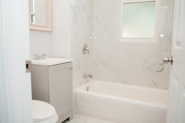 bathroom with marble finish floor, vanity, bathtub / shower combination, and toilet