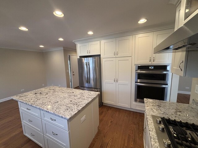 kitchen with recessed lighting, stainless steel appliances, dark wood-style flooring, wall chimney range hood, and crown molding