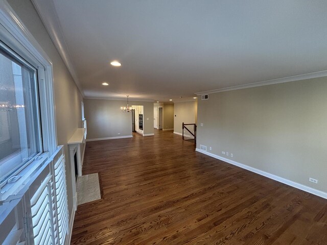 unfurnished living room with baseboards, crown molding, a chandelier, and dark wood-style flooring