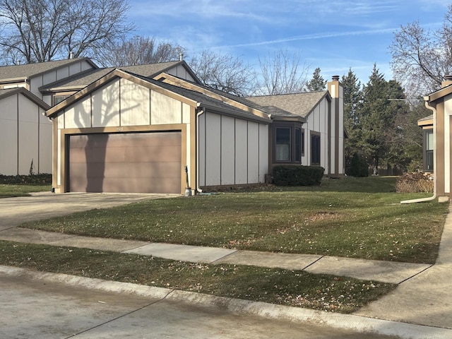 view of side of home featuring driveway, a garage, roof with shingles, a yard, and board and batten siding