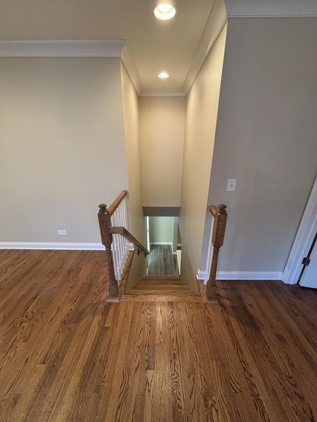 stairs featuring recessed lighting, crown molding, baseboards, and wood finished floors