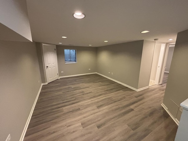 finished basement featuring baseboards, dark wood-type flooring, and recessed lighting