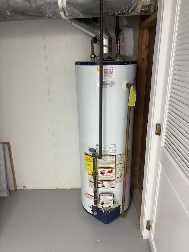 utility room featuring gas water heater