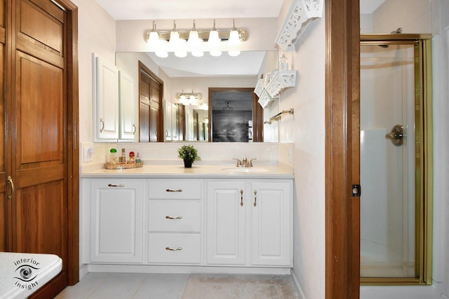 bathroom featuring decorative backsplash, tile patterned flooring, a shower stall, and vanity