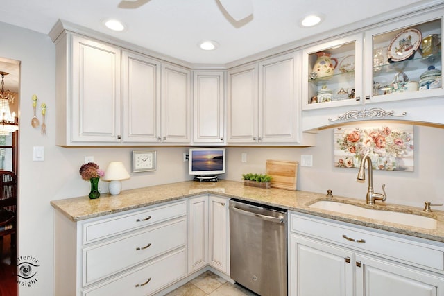 kitchen with recessed lighting, a sink, stainless steel dishwasher, and light stone countertops