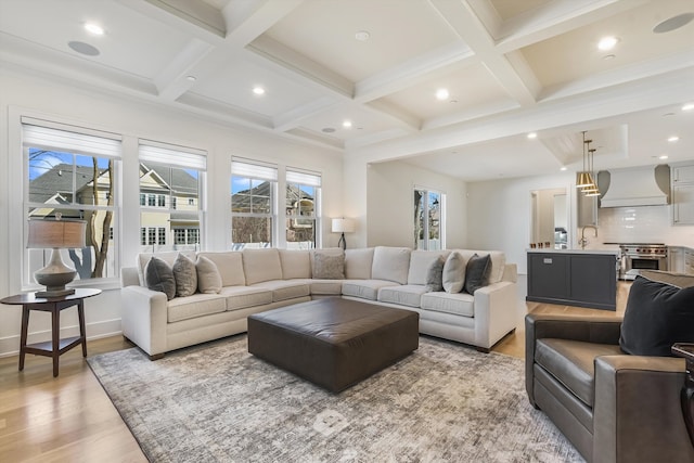 living area featuring beamed ceiling, recessed lighting, coffered ceiling, and light wood finished floors