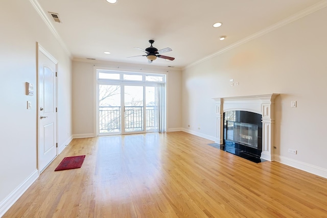 unfurnished living room featuring a fireplace with flush hearth, visible vents, ornamental molding, and light wood-style flooring