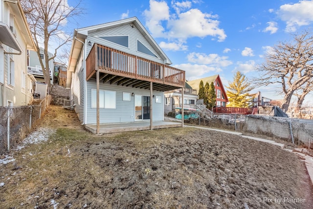 back of property featuring a deck, a patio, and fence private yard