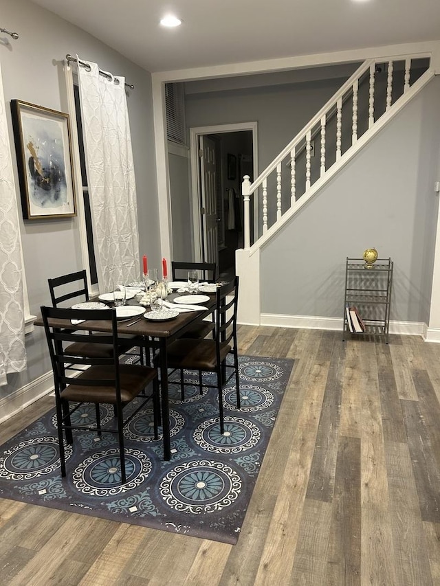 dining room with recessed lighting, stairs, baseboards, and wood finished floors