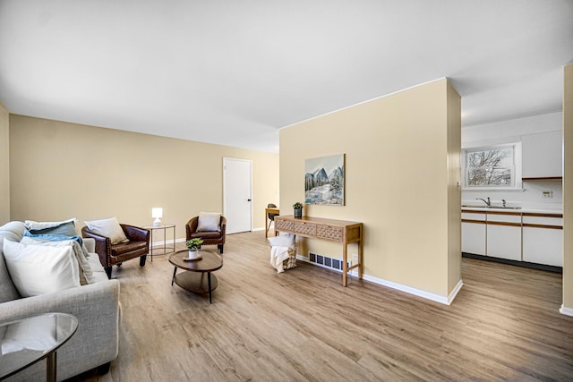 living room with baseboards and light wood-style floors