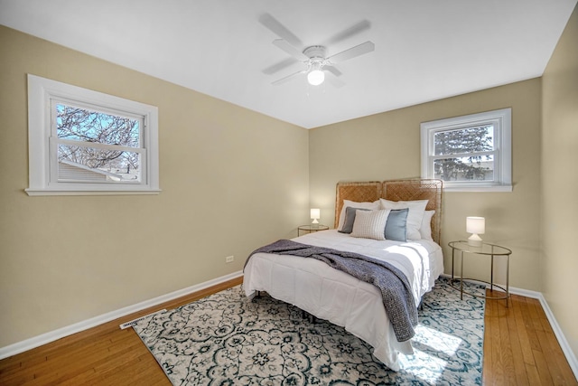 bedroom with a ceiling fan, baseboards, and hardwood / wood-style floors