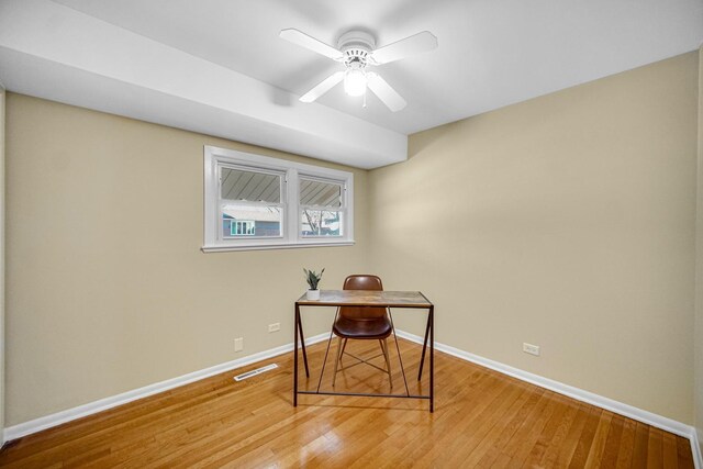 office with baseboards, a ceiling fan, visible vents, and light wood-style floors