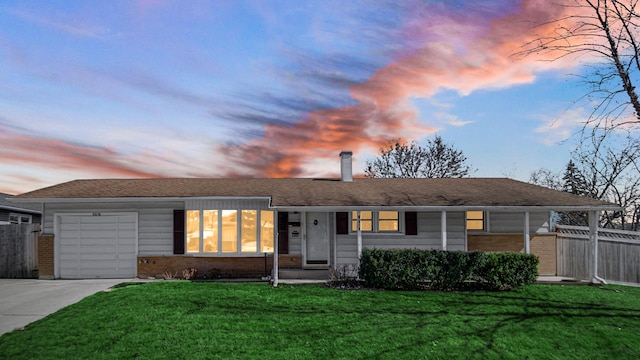 single story home featuring a garage, driveway, fence, a front lawn, and brick siding