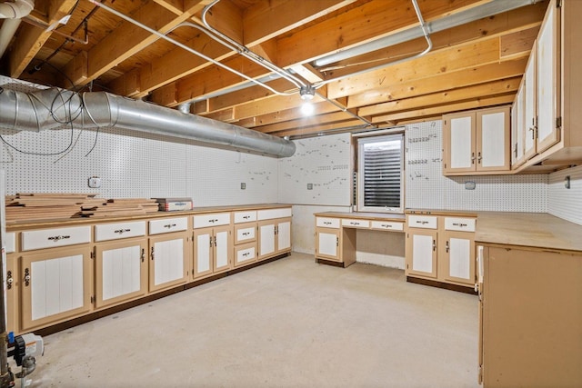 unfinished basement featuring a workshop area