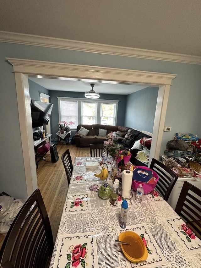 dining area featuring crown molding and wood finished floors