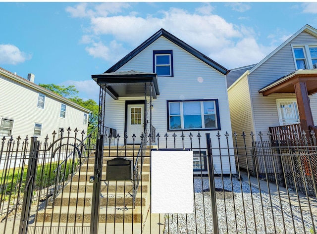 view of front of property featuring a fenced front yard and a gate