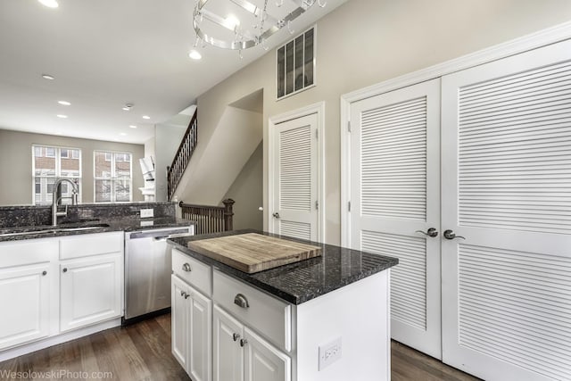 kitchen featuring a sink, dark wood-style floors, white cabinetry, and dishwasher