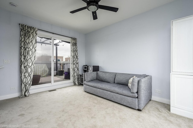 interior space featuring carpet floors, baseboards, visible vents, and ceiling fan