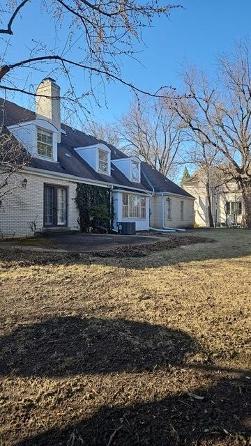 back of property with french doors and a chimney