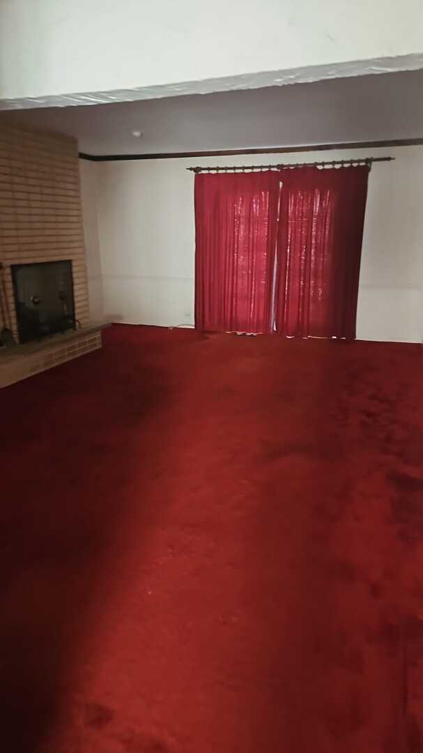 unfurnished living room featuring a brick fireplace