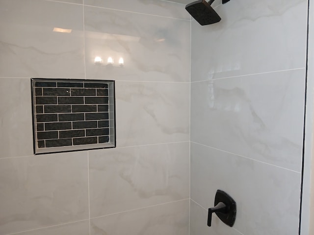 interior details featuring a tile shower