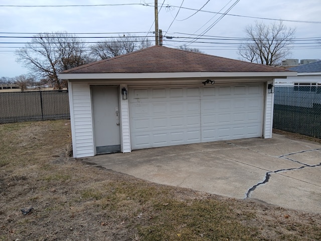 detached garage featuring fence