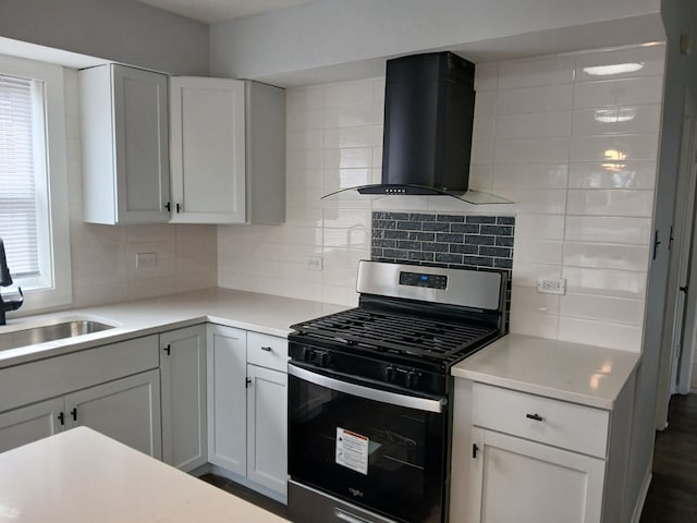 kitchen with plenty of natural light, backsplash, extractor fan, stainless steel range with gas cooktop, and a sink