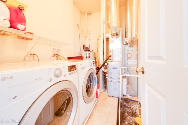 laundry area featuring laundry area, separate washer and dryer, and water heater