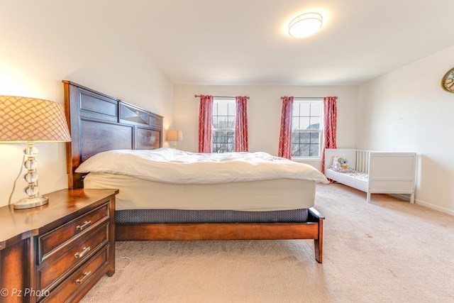 bedroom featuring baseboards and light carpet