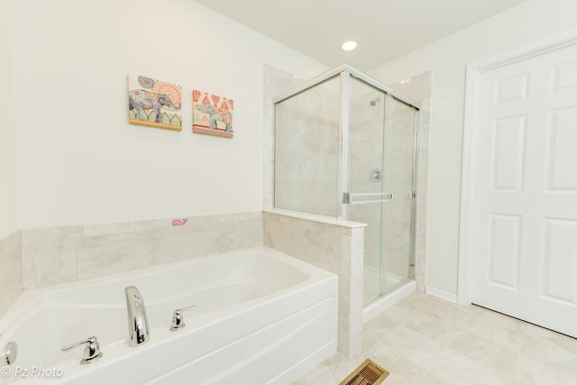 bathroom with a shower stall, a bath, recessed lighting, and visible vents