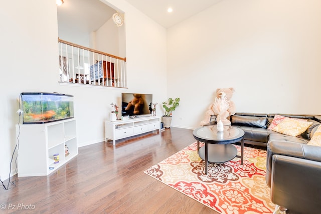 living room featuring recessed lighting, wood finished floors, and baseboards