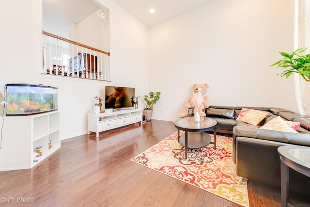 living room featuring recessed lighting, baseboards, and wood finished floors